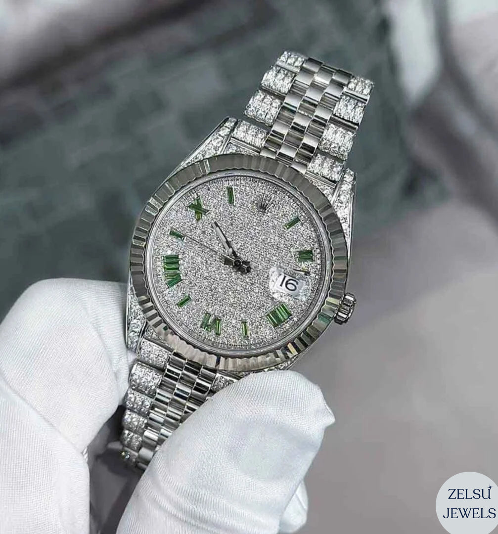 Silver diamond watch with a captivating green emerald diamond dial, offering luxury and elegance.