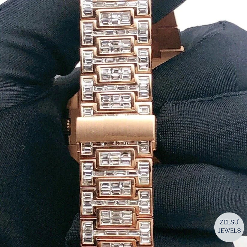 Exquisite emerald diamond rose gold bust-down watch with sparkling emerald diamonds covering the design.