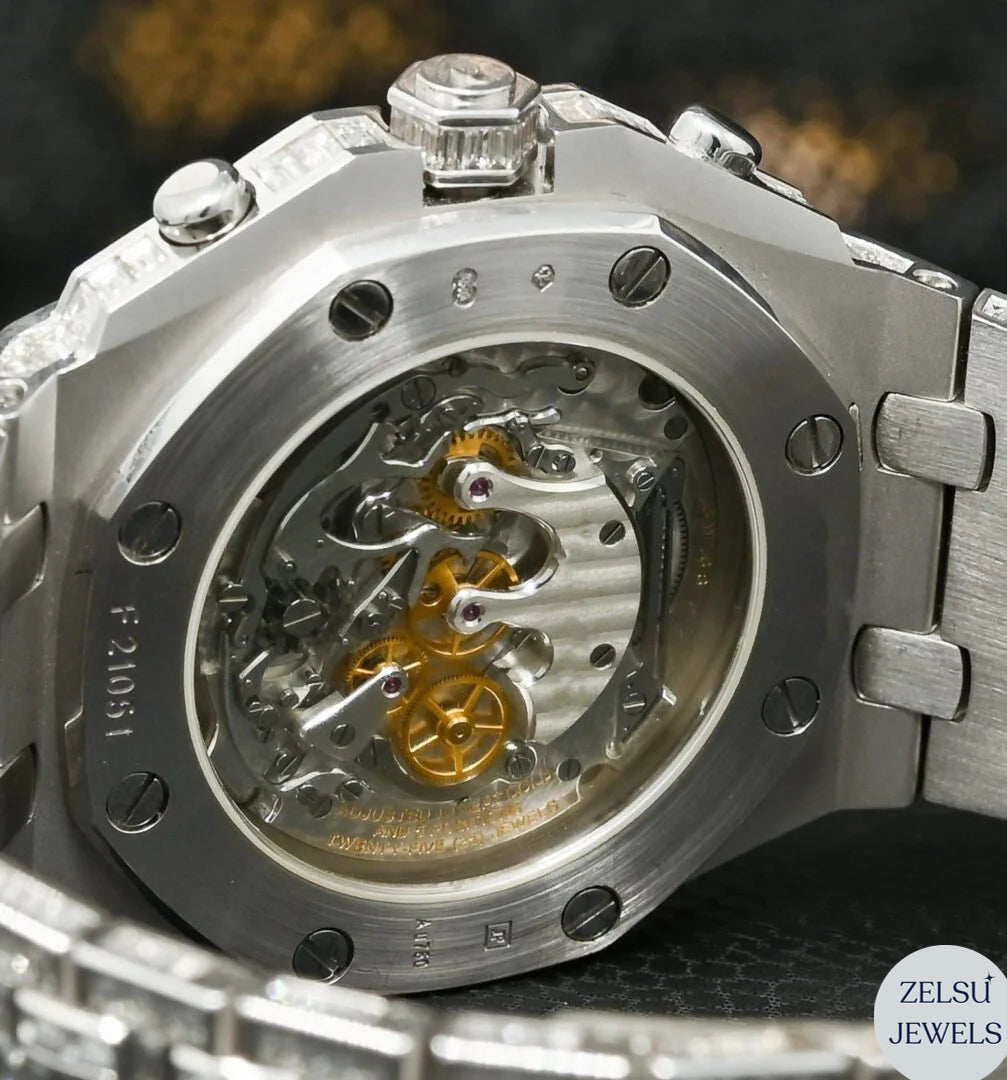 Sophisticated silver watch featuring emerald bezel and full bust-down diamond detailing for an opulent look.