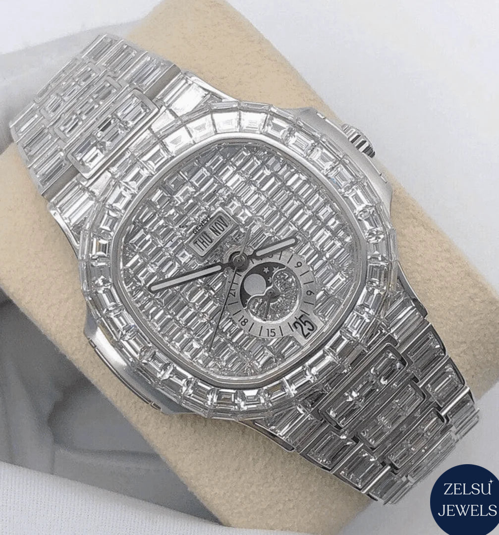 Luxury silver watch with emerald bezel and diamond bust-down detailing, offering a combination of elegance and color.