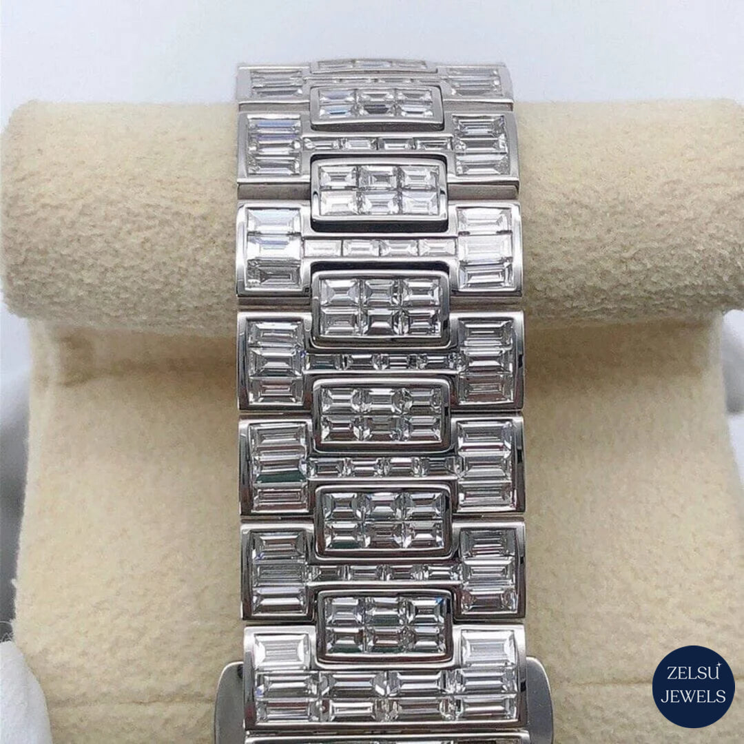 Opulent silver watch with emerald bezel and full bust-down diamond embellishments, perfect for fashion-forward individuals.