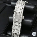 Elegant silver automatic watch featuring emerald diamonds for a touch of luxury.