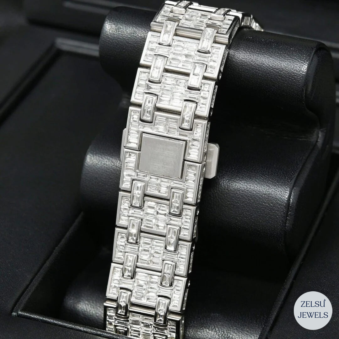 Elegant silver automatic watch featuring emerald diamonds for a touch of luxury.