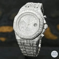Luxury silver automatic watch with emerald diamond accents, combining style and precision.