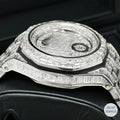 Silver automatic watch with dazzling emerald diamonds, blending luxury and craftsmanship
