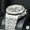 Sleek silver automatic watch with emerald diamonds for a sophisticated and modern design.