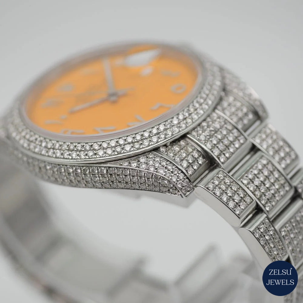 Sophisticated silver diamond watch with an orange crystal dial and sparkling diamond bezel for a unique luxury design.