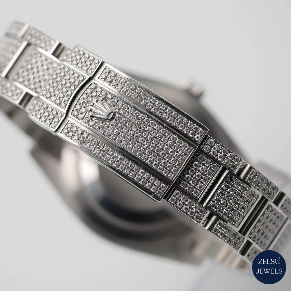 Silver diamond watch with an orange crystal dial and sparkling diamond bezel, ideal for those who appreciate bold luxury.