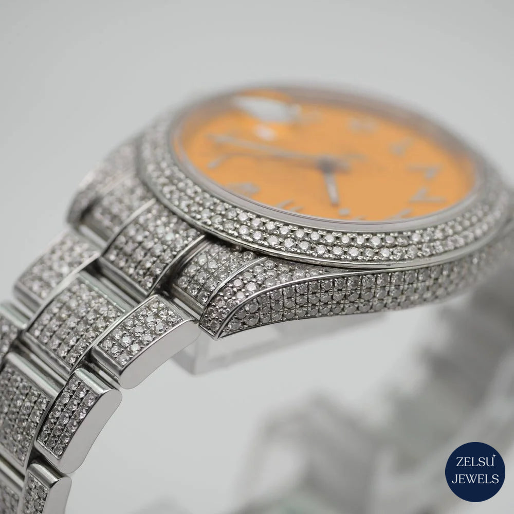 Radiant silver diamond watch with orange crystal dial and diamond bezel, combining bold color and sophisticated elegance.