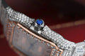 Stunning bust-down diamond watch featuring a blue diamond crown bezel for a unique and luxurious look.